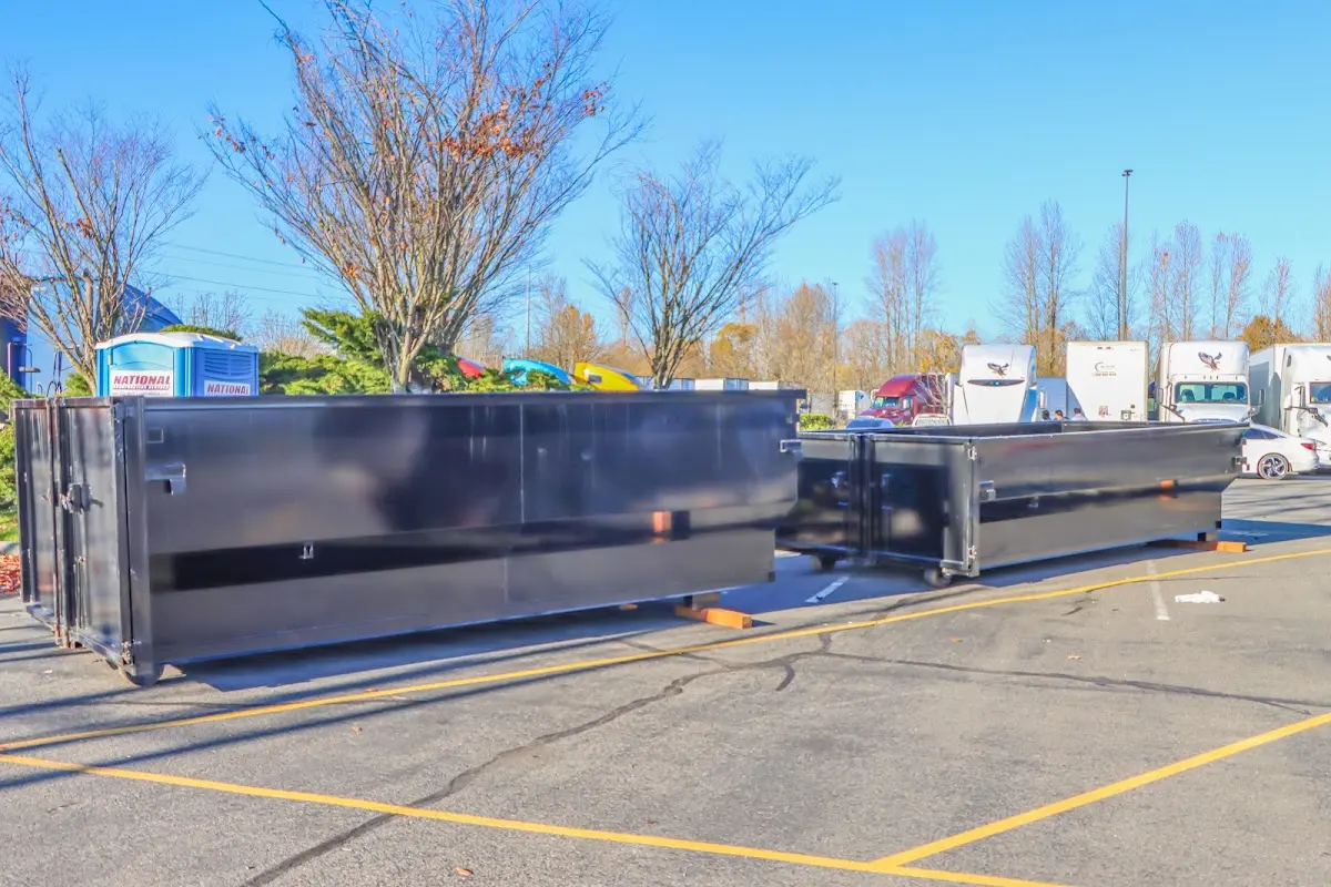 Professional dumpster rental service with roll-off container on residential driveway in Roseland